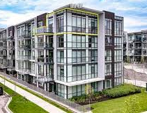 Innisfil apartment for rent - A modern multi-story building with large windows and balconies.