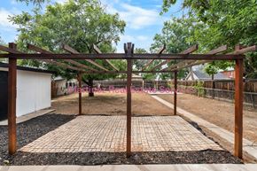 Denver house for rent - A wooden pergola with a brick walkway in the foreground.