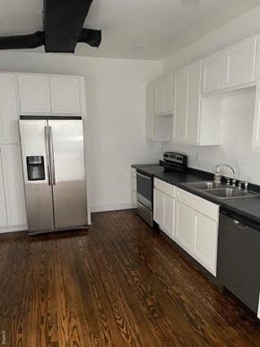 St. Louis house for rent - A kitchen with a stainless steel refrigerator and black countertops.
