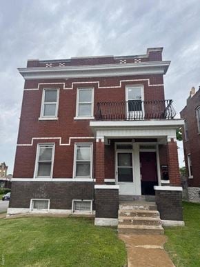 St. Louis house for rent - A red brick house with a white door and windows.