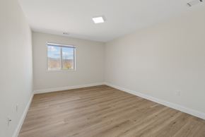 Altoona apartment for rent - Empty room with wooden flooring and a window.