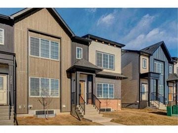 Chestermere apartment for rent - A row of modern houses with different colored exteriors.