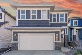 Chestermere apartment for rent - A modern two-story house with a white garage door.