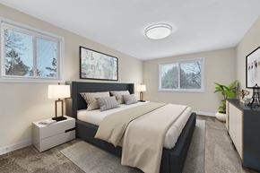 Silver Spring apartment for rent - A bedroom with a large bed and a window with blinds.