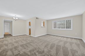 Silver Spring apartment for rent - A spacious room with a carpeted floor and a window showing a snowy scene outside.