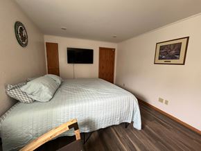 Manvel apartment for rent - A bedroom with a bed, a flat screen TV, and a picture on the wall.