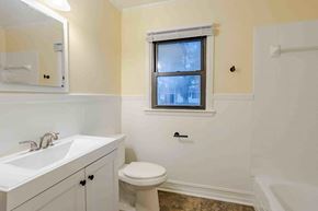 Lafayette house for rent - A bathroom with a toilet, sink, and tub.