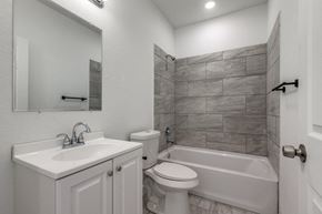 San Antonio apartment for rent - A bathroom with a white sink, toilet, and bathtub.