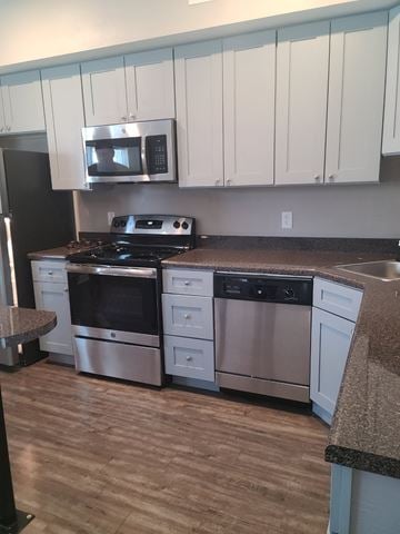 Little Rock apartment for rent - A kitchen with a black refrigerator and stainless steel appliances.