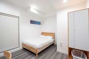 Los Angeles apartment for rent - A bedroom with a bed, a chair, and a basket.