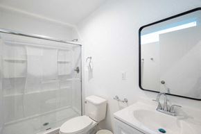 Los Angeles apartment for rent - A white bathroom with a toilet, sink, and shower.
