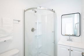 Los Angeles apartment for rent - A white bathroom with a glass shower door and a white sink.