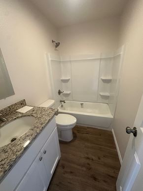 Big Spring apartment for rent - A white bathroom with a sink, toilet, and bathtub.