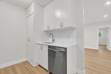 Cambridge apartment for rent - A kitchen with white cabinets and a dishwasher.