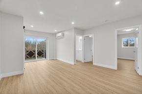 Cambridge apartment for rent - A spacious room with wooden flooring and white walls.
