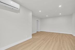 Cambridge apartment for rent - A room with a wooden floor and a wall-mounted air conditioner.
