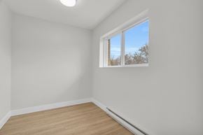Cambridge apartment for rent - A room with a window and a wooden floor.