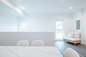 Los Angeles apartment for rent - A white table with chairs and a sofa in a room.