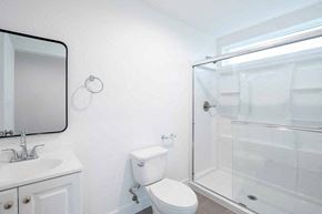 Los Angeles apartment for rent - A white bathroom with a toilet, sink, and shower.