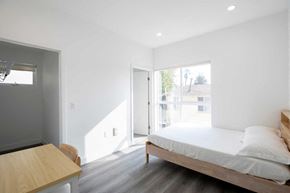 Los Angeles apartment for rent - A bedroom with a bed, nightstand, and window.