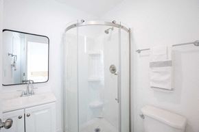 Los Angeles apartment for rent - A white bathroom with a glass shower door and a white toilet.