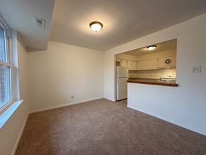 Fairless Hills apartment for rent - A room with wooden flooring and white walls.