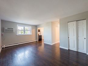 Bridgeport apartment for rent - A white bathroom with a tub, sink, and mirror.