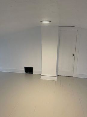 Akron house for rent - A black box is on the floor of a white room.