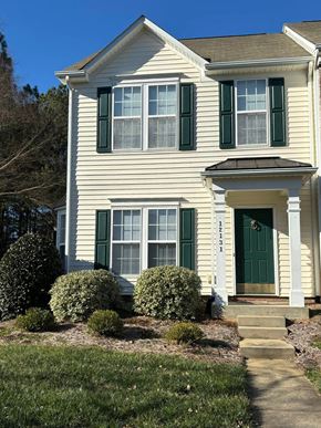 Huntersville house for rent - A white house with green shutters and a green door.