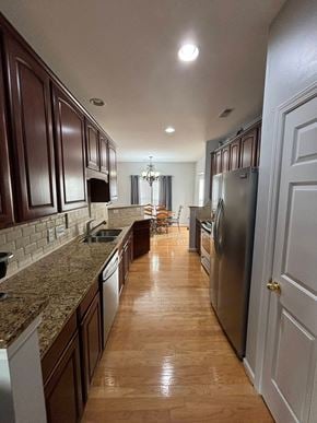 Huntersville house for rent - A kitchen with brown cabinets and a marble countertop.
