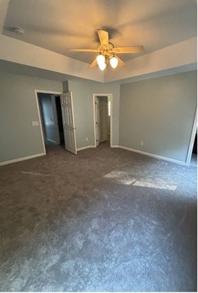 Huntersville house for rent - A room with a ceiling fan and carpeted floor.