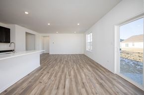 Winfield house for rent - A spacious room with wooden flooring and white walls.