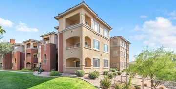 Phoenix apartment for rent - A large, multi-story residential building with a green lawn in front.