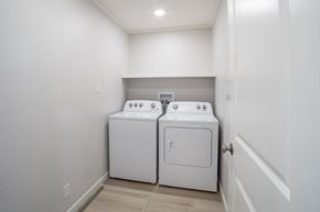 Saskatoon apartment for rent - A white washer and dryer in a small laundry room.