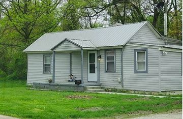 Essex house for rent - A small house with a grey siding and a white door.