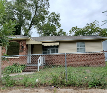 Jacksonville house for rent - A house with a fence and a tree in front of it.