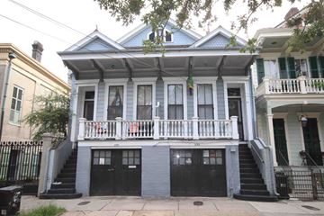 New Orleans apartment for rent - A blue house with a black door and a black gate.