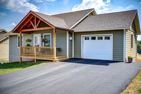 Boone house for rent - A house with a white garage door and a brown porch.
