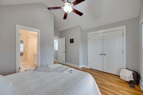Nashville house for rent - A bedroom with a large bed and a ceiling fan.