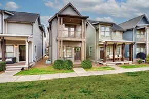 Nashville house for rent - A row of houses with green lawns in front.