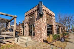 Nashville house for rent - A brick building with a black sign on the front.