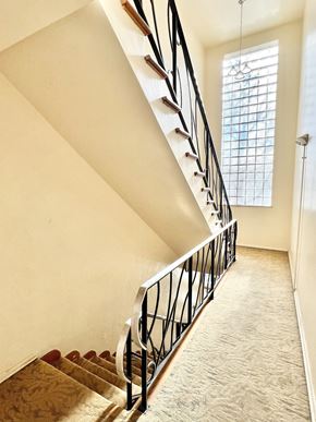 Denver apartment for rent - A staircase with a metal railing and wooden steps.