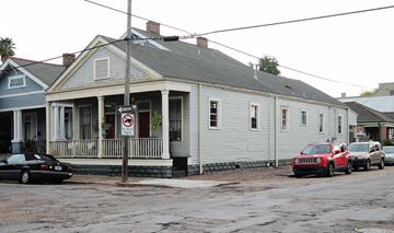 New Orleans apartment for rent - A car is parked in front of a building with a no parking sign.