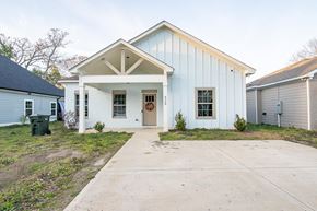 Phenix City house for rent - A blue and white house with a front porch.