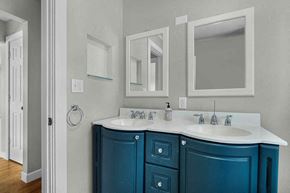 Grand Rapids house for rent - A bathroom with a white counter top and blue cabinets.