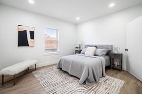 Elizabeth apartment for rent - A bedroom with a large bed and a bench.