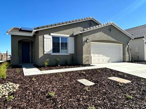 Manteca house for rent - A house with a grey roof and a white garage door.