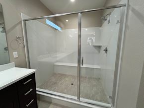 Manteca house for rent - A white bathroom with a walk in shower.