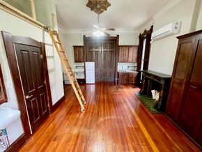 Louisville apartment for rent - A room with wooden floors and a ladder in it.