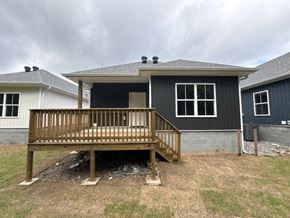 Little Rock house for rent - A house with a grey roof and a wooden deck.